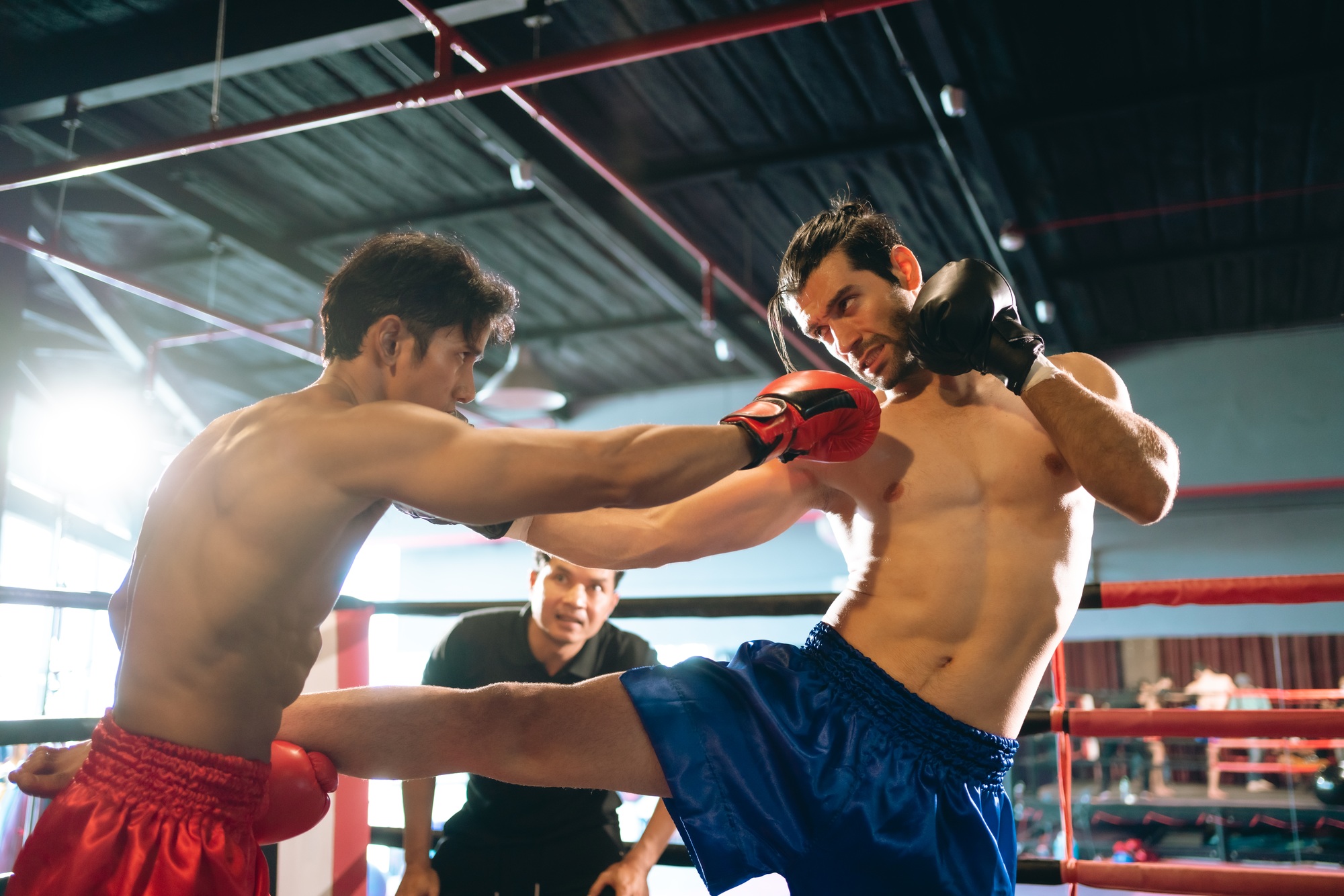 MMA or Thai Boxing match, Two professional fighters punching or boxing, Gym atmosphere